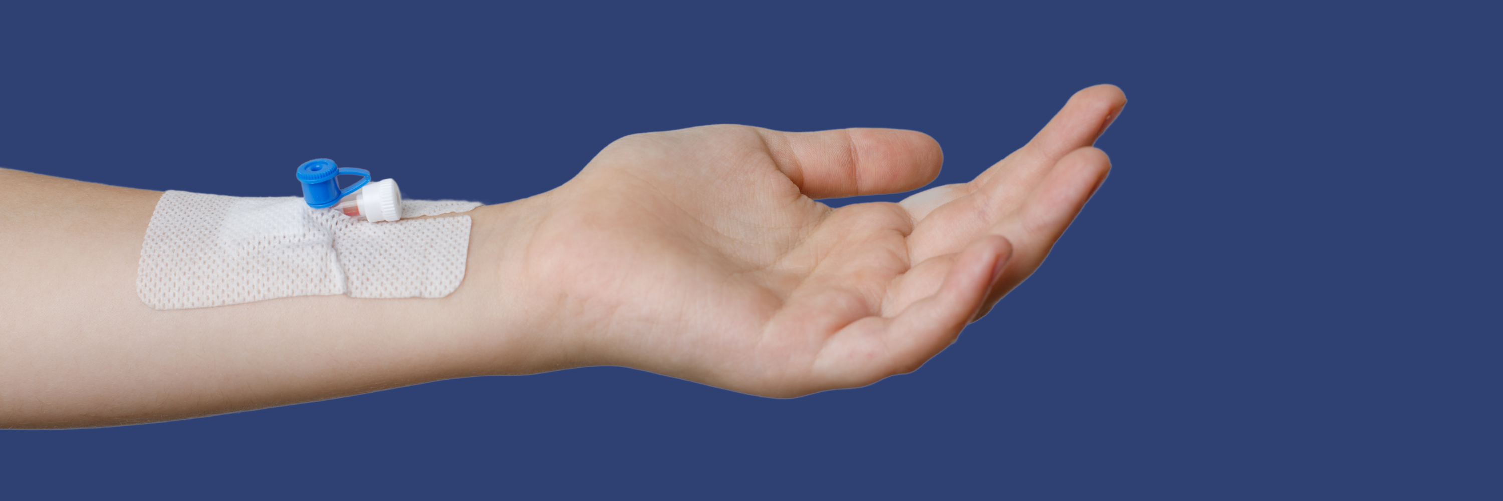 A hand is extended with a bandaged area on the wrist, containing a blue and white medical device, indicating a recent procedure or intravenous access. The background is a solid blue color.